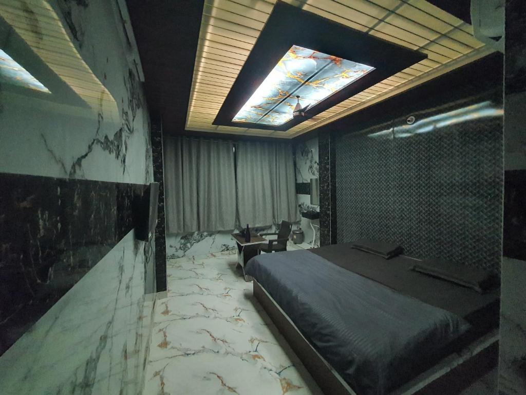 a bedroom with a bed and a skylight at SRS GRAND in Hyderabad