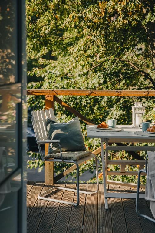 a table and a chair on a deck with a table at 20 stairs in Vilnius