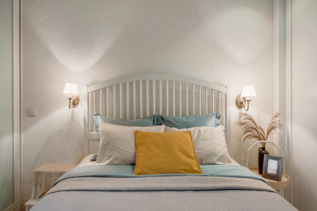 a bedroom with a large bed with a yellow pillow at 20 stairs in Vilnius
