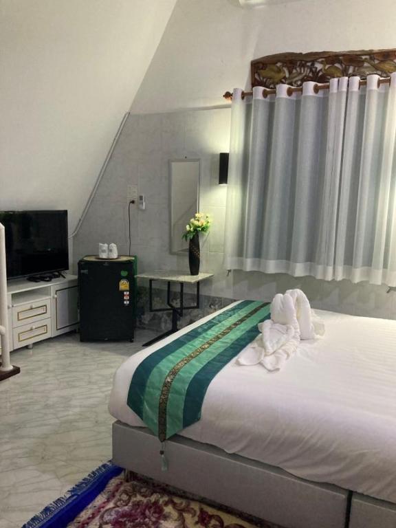 Voodi või voodid majutusasutuse วิวธารารีสอร์ท (ViewThara Resort) toas