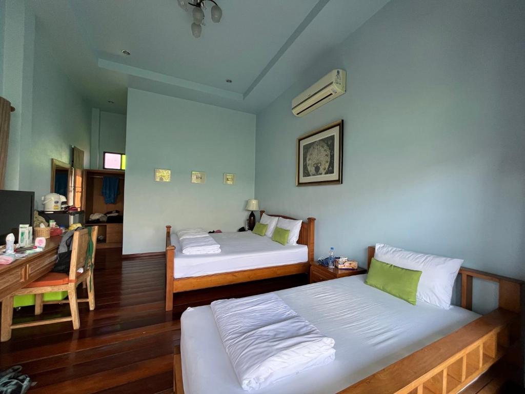 Un pat sau paturi într-o cameră la Baan Pai Nai Wieng