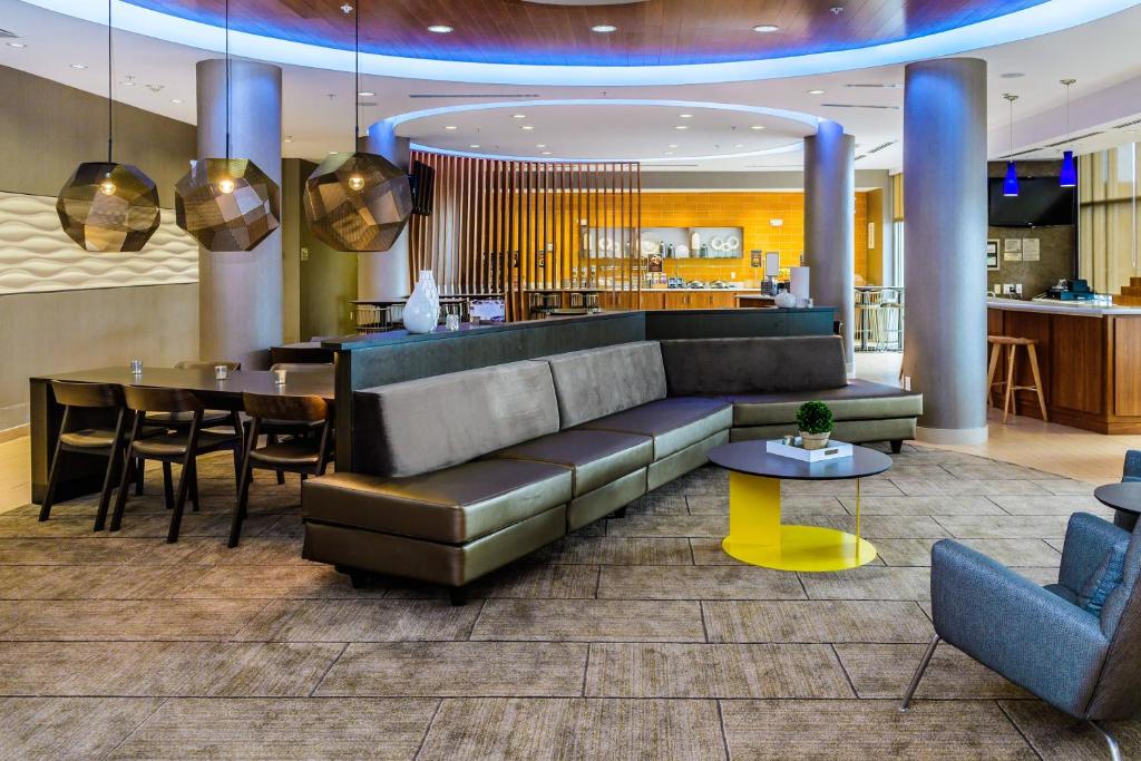 a lobby with a couch and a dining room at SpringHill Suites Houston NASA/Seabrook in Seabrook