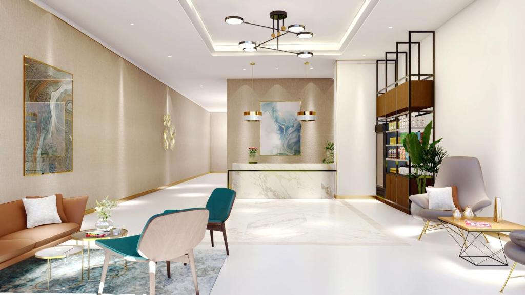 a lobby with chairs and tables and a counter at Staybridge Suites Dubai Business Bay, an IHG Hotel in Dubai