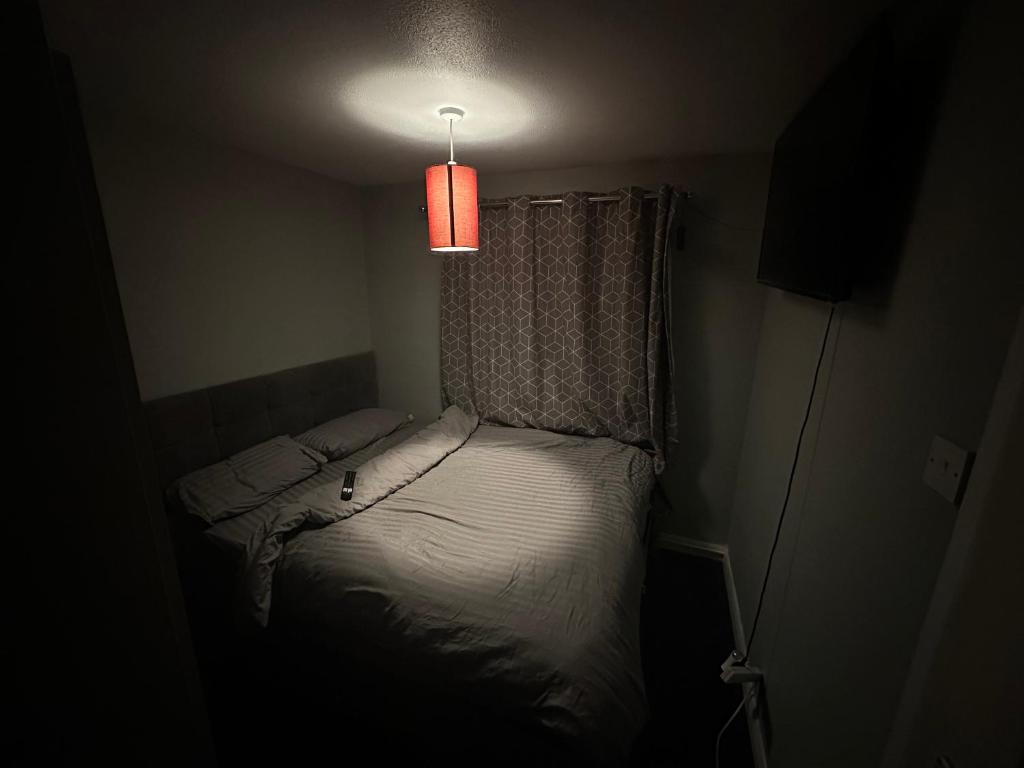 a small bed in a room with a light at 1 bedroom in 3bed house in Bristol