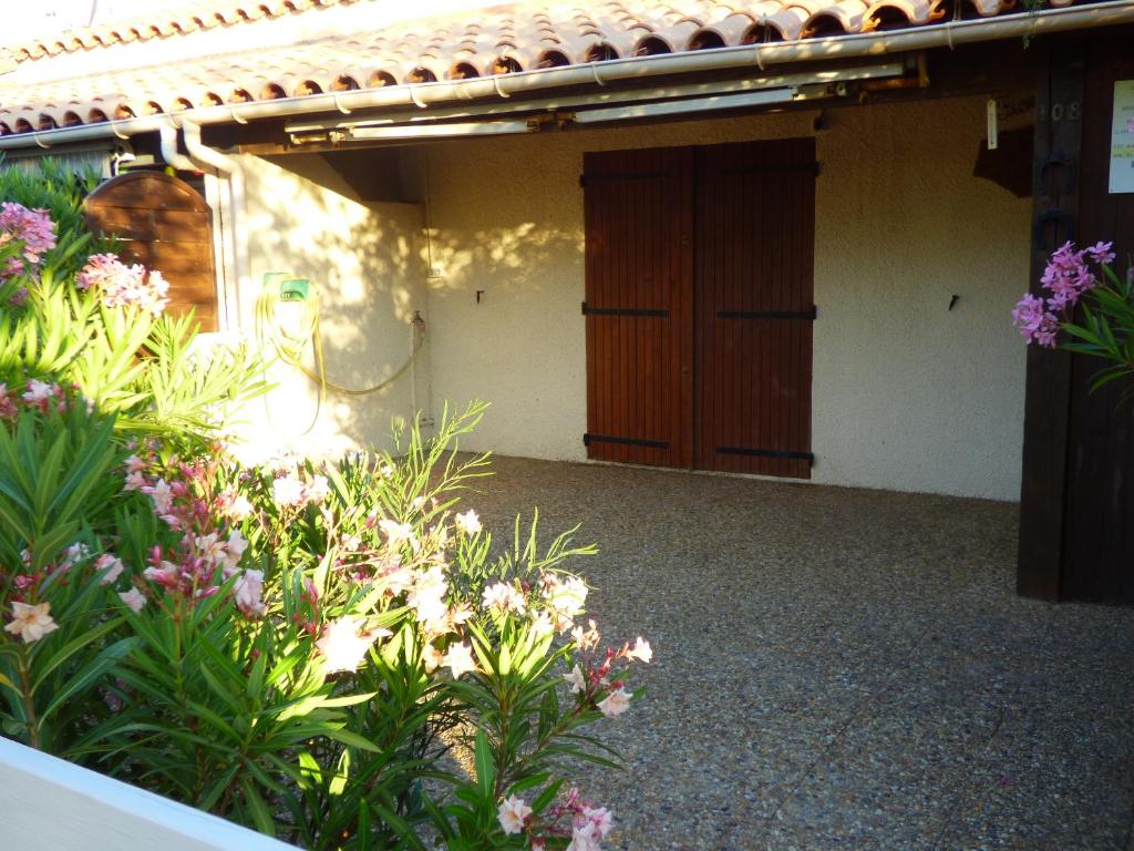 un bâtiment avec un bouquet de fleurs devant dans l'établissement FINETTE 4A 2E 1BB Park, à Gruissan