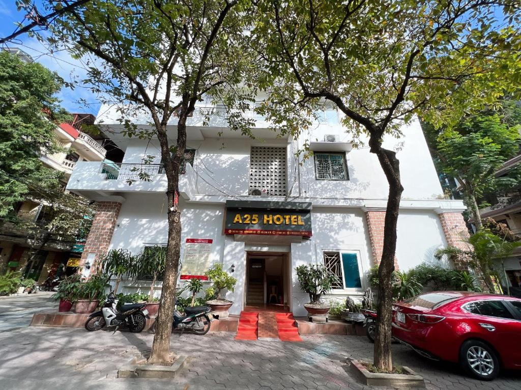 hotel with cars parked in front of it at A25 Hotel - Hoàng Quốc Việt in Hanoi