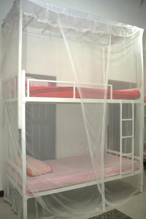 Postel nebo postele na pokoji v ubytování Traveller's Hostel Hikkaduwa