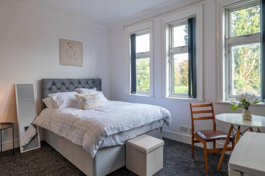 a bedroom with a bed and a table and chairs at Parkview Studio: Studio Suite 9 in Parkside