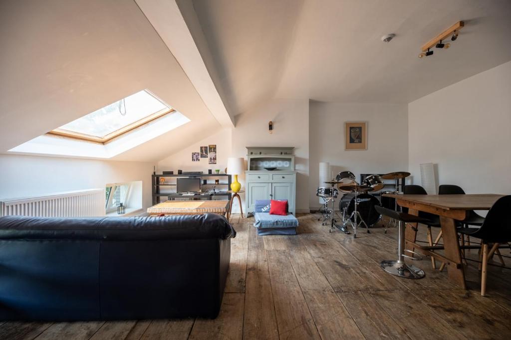 a living room with a couch and a table at Appartement Bronckart_10 in Liège