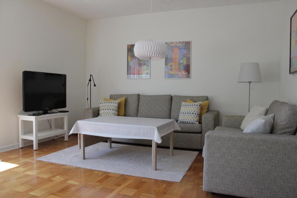a living room with a couch and a coffee table at Villa Hassel in Middelfart