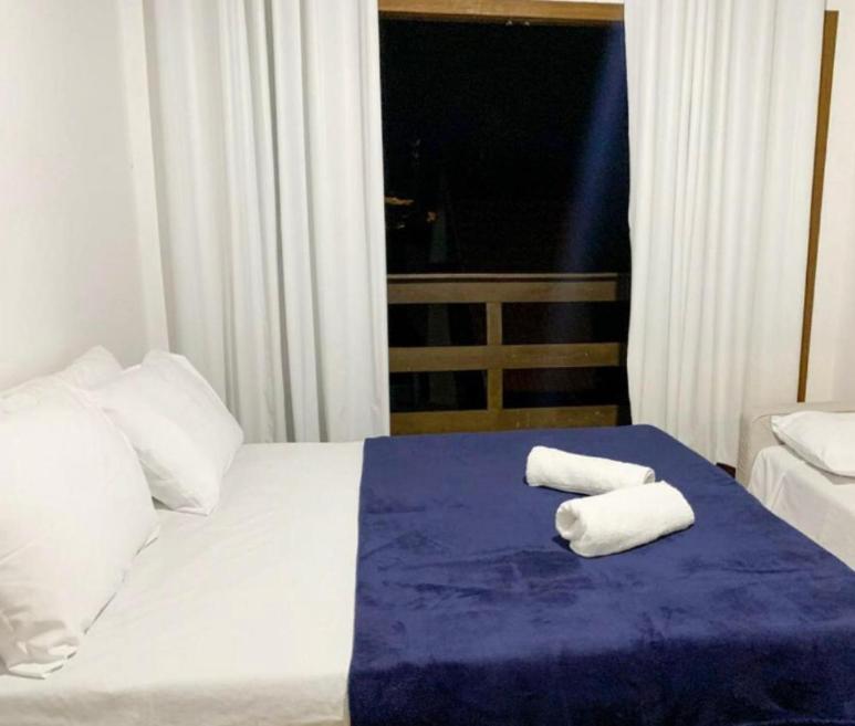 a hotel room with two towels on a bed at Golden Residence in Florianópolis