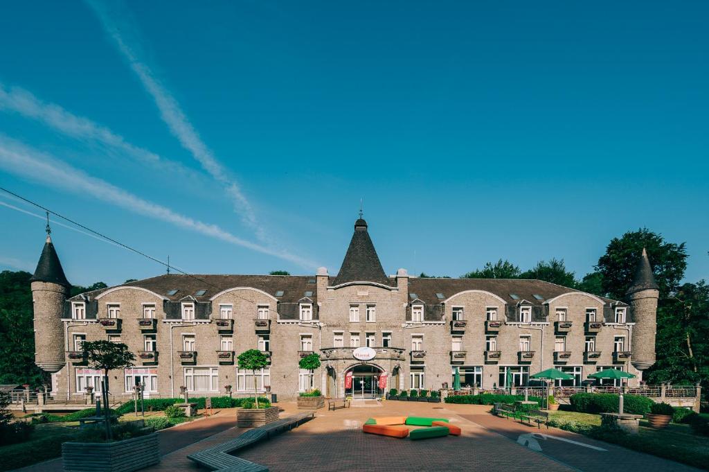 a large tan building with a large building at Floreal La Roche-en-Ardenne in La Roche-en-Ardenne