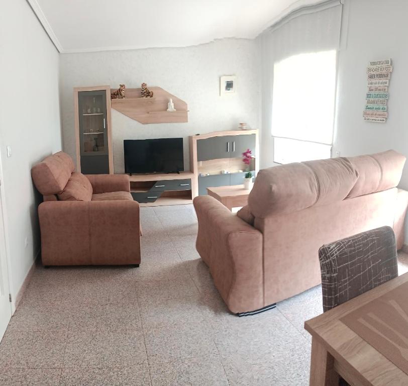 a living room with two couches and a television at Tu Apartamento Ideal in Ponferrada