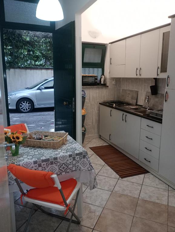a kitchen with a table and a chair and a car at Matteo's House Taormina in Taormina