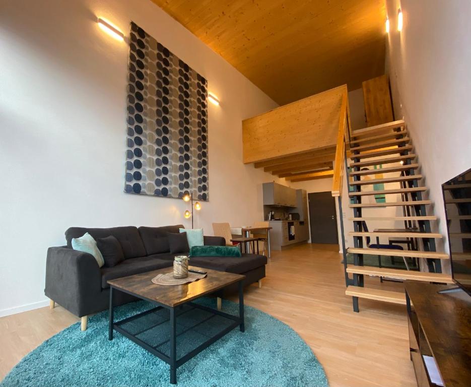 ein Wohnzimmer mit einem Sofa und einem Tisch in der Unterkunft Loft 53 in Goldkronach