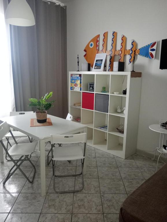 a dining room with a white table and chairs at Matteo's House Taormina in Taormina
