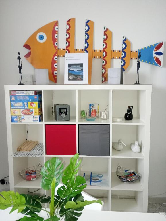 a white book shelf with a tv on it at Matteo's House Taormina in Taormina