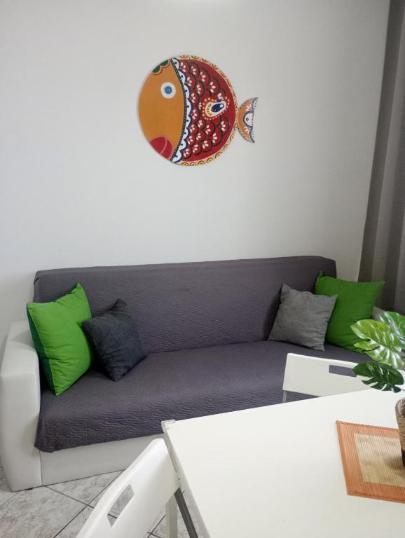 a living room with a couch with a fish on the wall at Matteo's House Taormina in Taormina