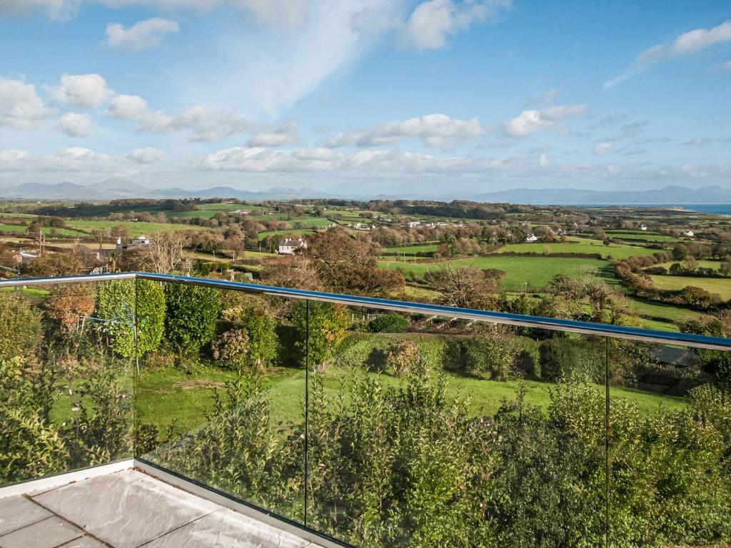 einen Glasbalkon mit Blick auf die Landschaft in der Unterkunft Sgwner View in Abererch