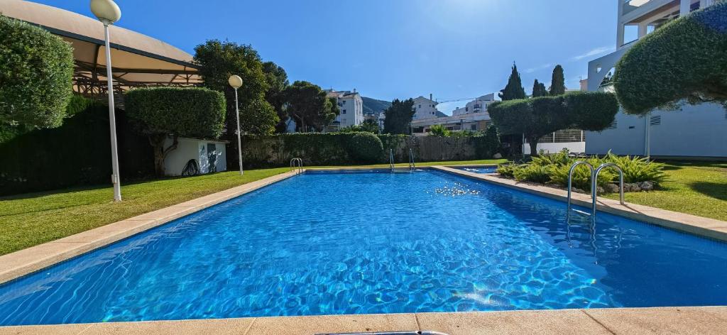 a large blue swimming pool in a yard at Residencial Aventino en pleno centro del L'Albir in Albir