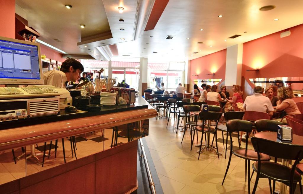 a man standing at a counter in a restaurant at Hotel Jucamar in Cangas de Morrazo
