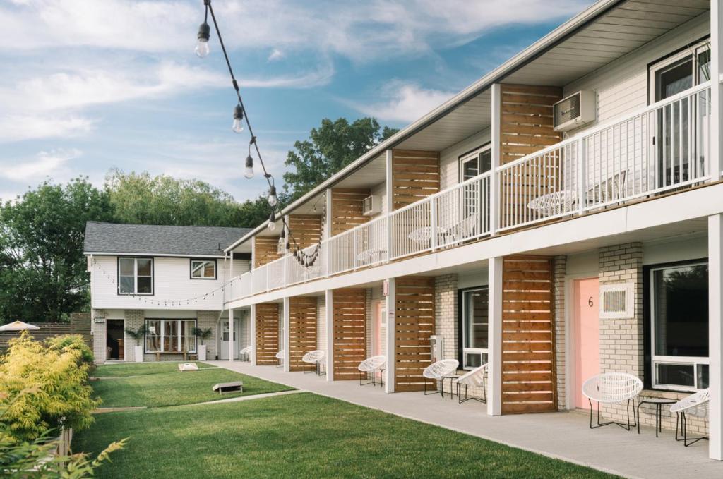 an exterior view of a building with a yard at The June Motel in Picton