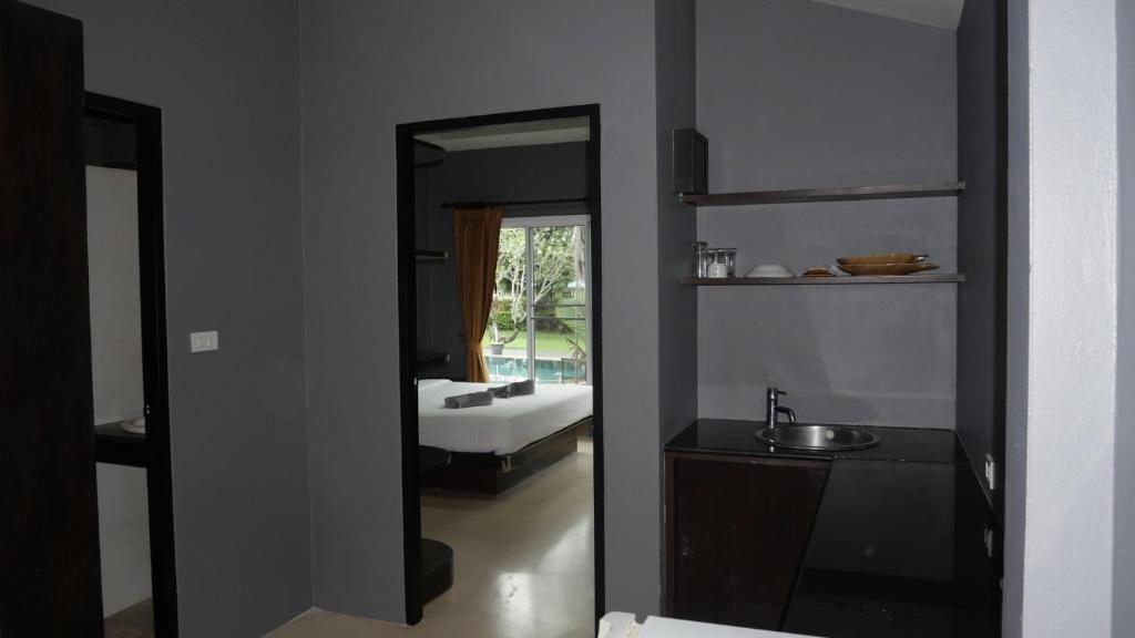 a bathroom with a mirror and a sink and a tub at Mindful Kinesics Wellness Living in Amphoe Koksamui