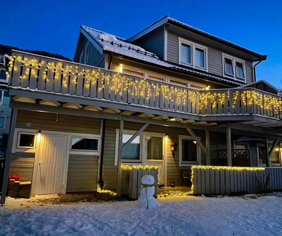 a house with christmas lights on the balcony at Appartment close to the city, ocean and mountains -Tromsø in Tromsø