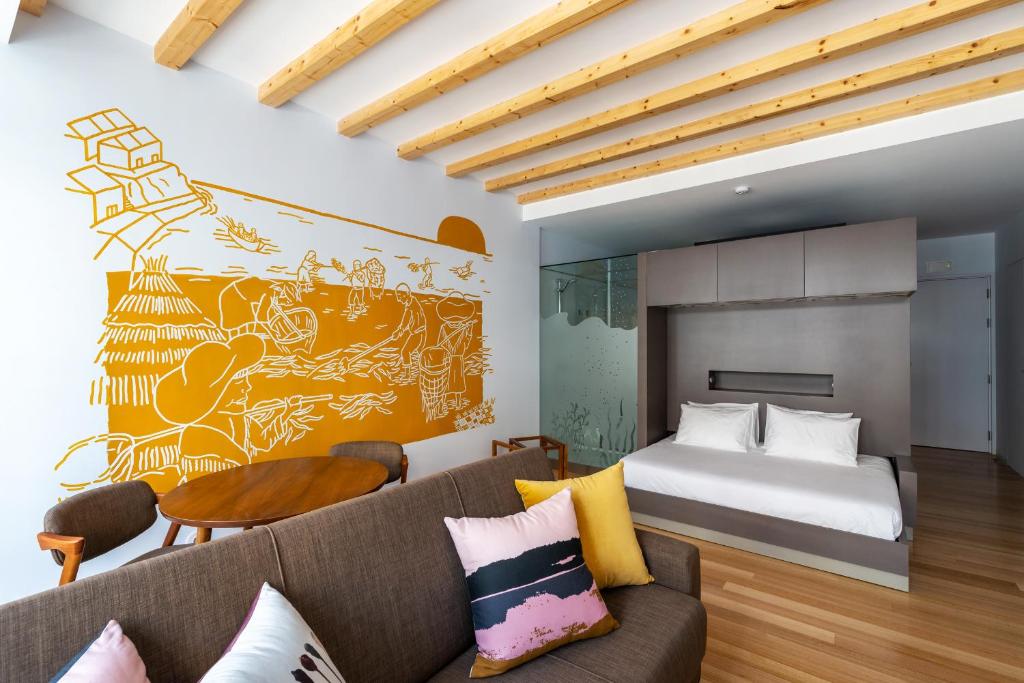 Een bed of bedden in een kamer bij Pensao O Laranjeira