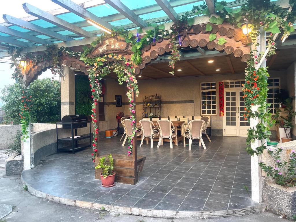 a pergola with a table and chairs on a patio at 寧靜的家14人Villa獨立設施包棟戲水池烤肉區麻將廚房私人停車場 in Hengchun South Gate