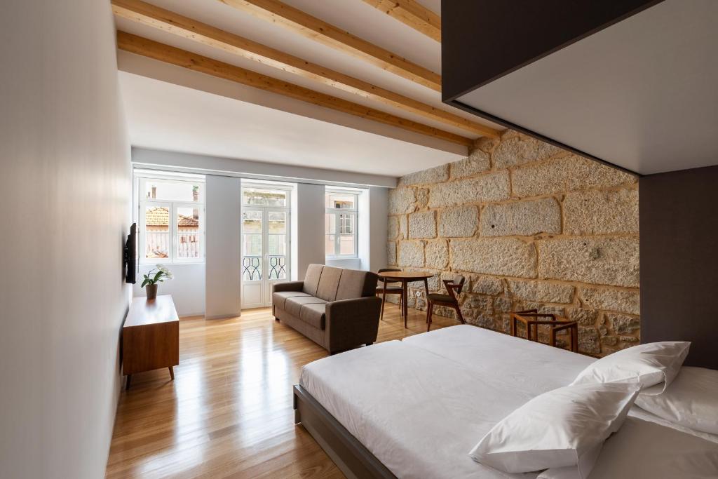 Een bed of bedden in een kamer bij Pensao O Laranjeira