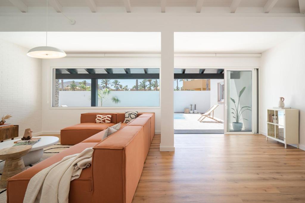 a living room with a couch and a table at Villa Tropico - Design house with pool in Corralejo in Corralejo