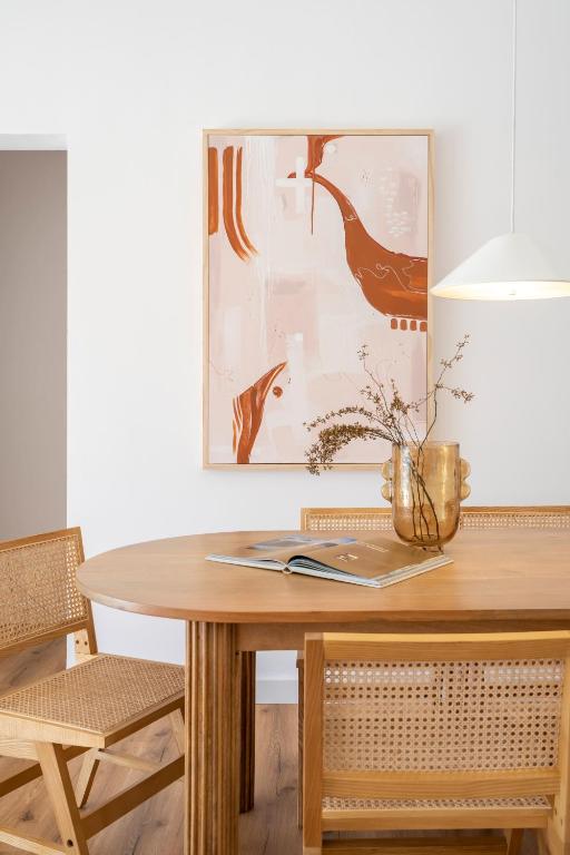 a dining room table with a vase on it at Villa Tropico - Design house with pool in Corralejo in Corralejo