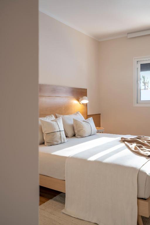 a bedroom with a large white bed with white pillows at Villa Tropico - Design house with pool in Corralejo in Corralejo
