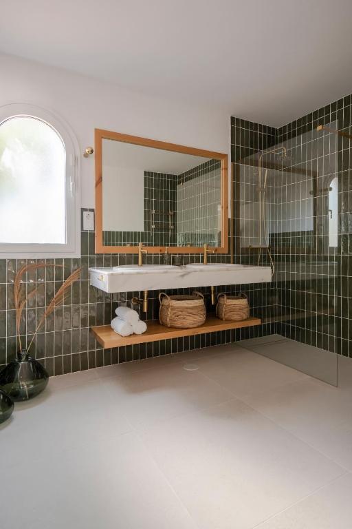 a bathroom with a sink and a mirror at Villa Tropico - Design house with pool in Corralejo in Corralejo