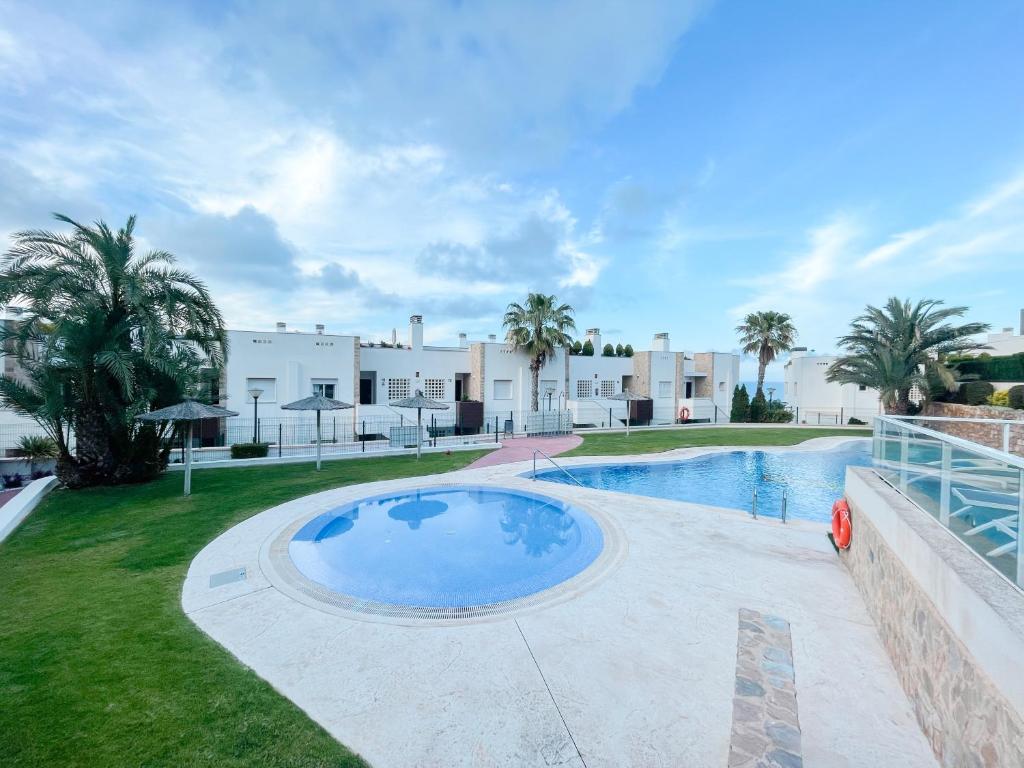 a large swimming pool in the backyard of a house at Nova Beach Apartment 41 in Gran Alacant