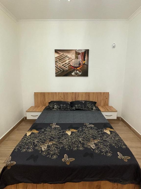 um quarto com uma cama com uma colcha preta em Militari Comfort Studio em Roşu