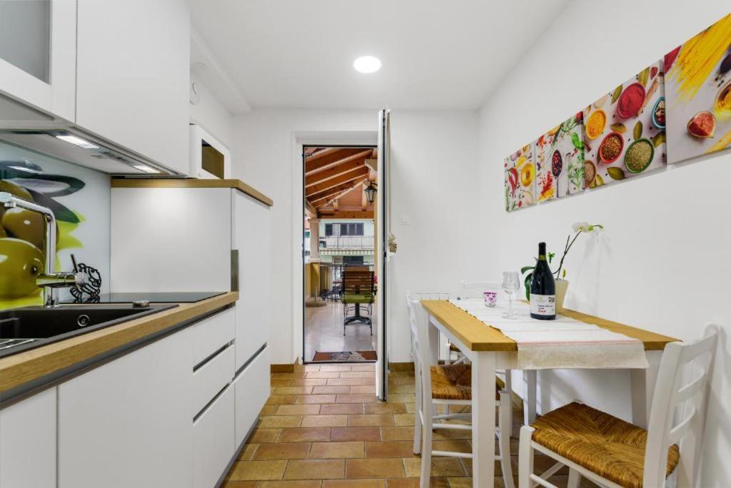 a kitchen with a table and a dining room at Guesthouse Casa Nova in Poreč