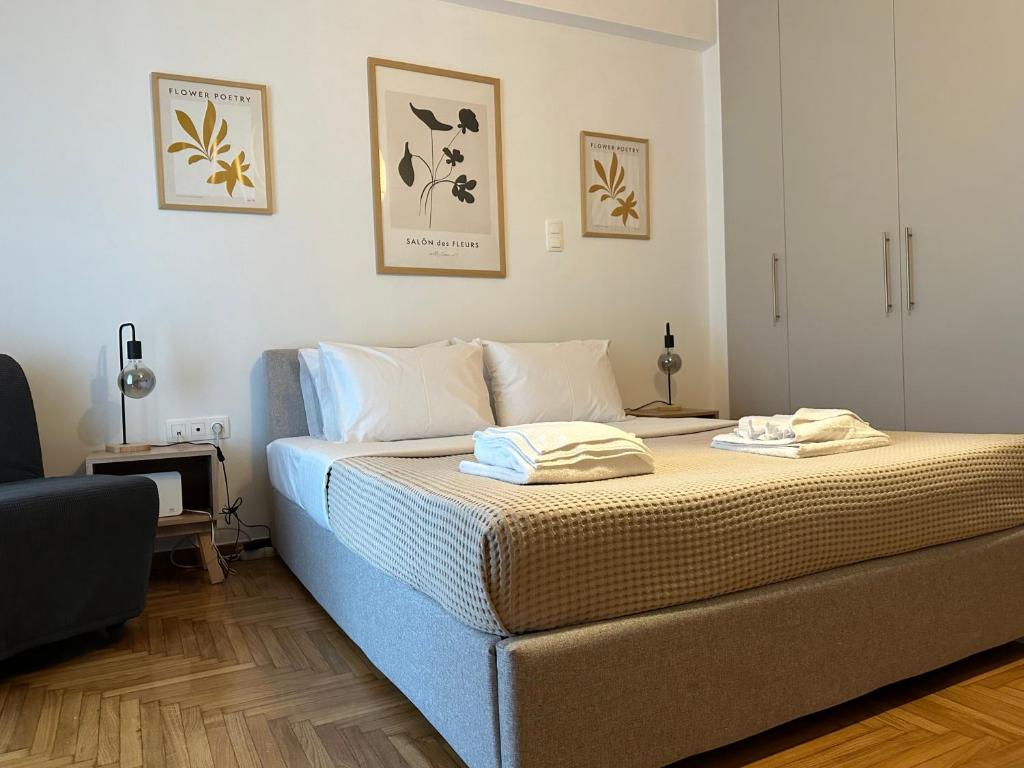 1 dormitorio con 1 cama con 2 toallas en Cozy Faliro home en Piraeus