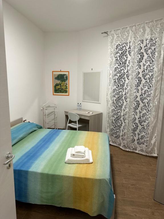 a bedroom with a bed and a table and a desk at SAMMARTINO LUXURY APARTMENT in Palermo