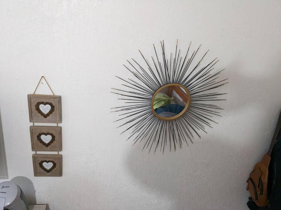 a mirror is hanging on a wall at Le nid in La Bourboule