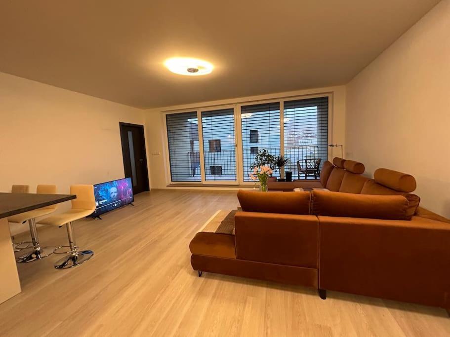 a living room with a couch and a table at New apartment “pod papiernou” in Bardejov