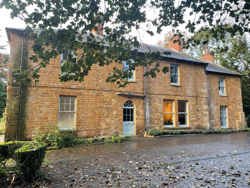 an old brick building with an open door at The Old Vicarage in Flore