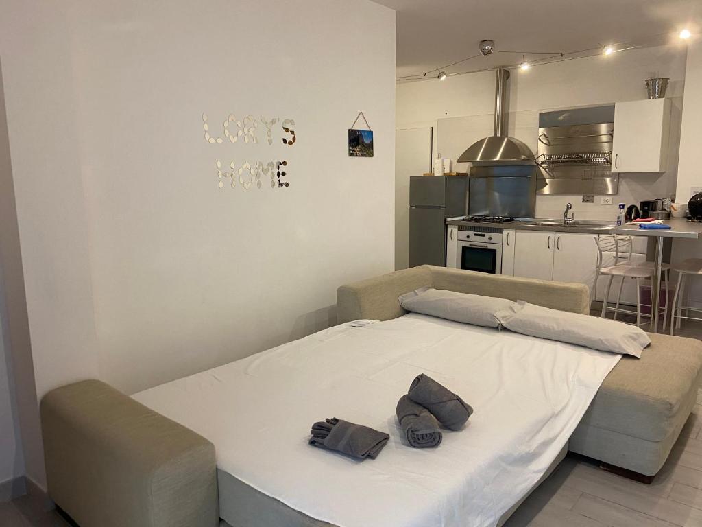 a room with a bed and a kitchen at Bari Lory’s Home in Bari