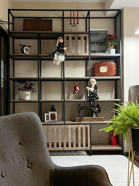 a room with a shelf with dolls on it at Hotel Sky Station in Tbilisi City