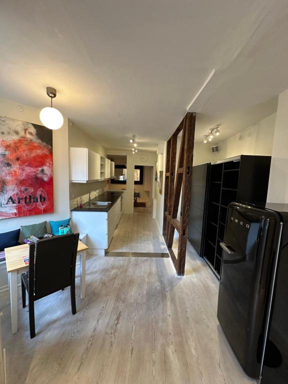 a living room with a kitchen and a dining room at Central, Historical, Unique & Modern Apartment CPH in Copenhagen