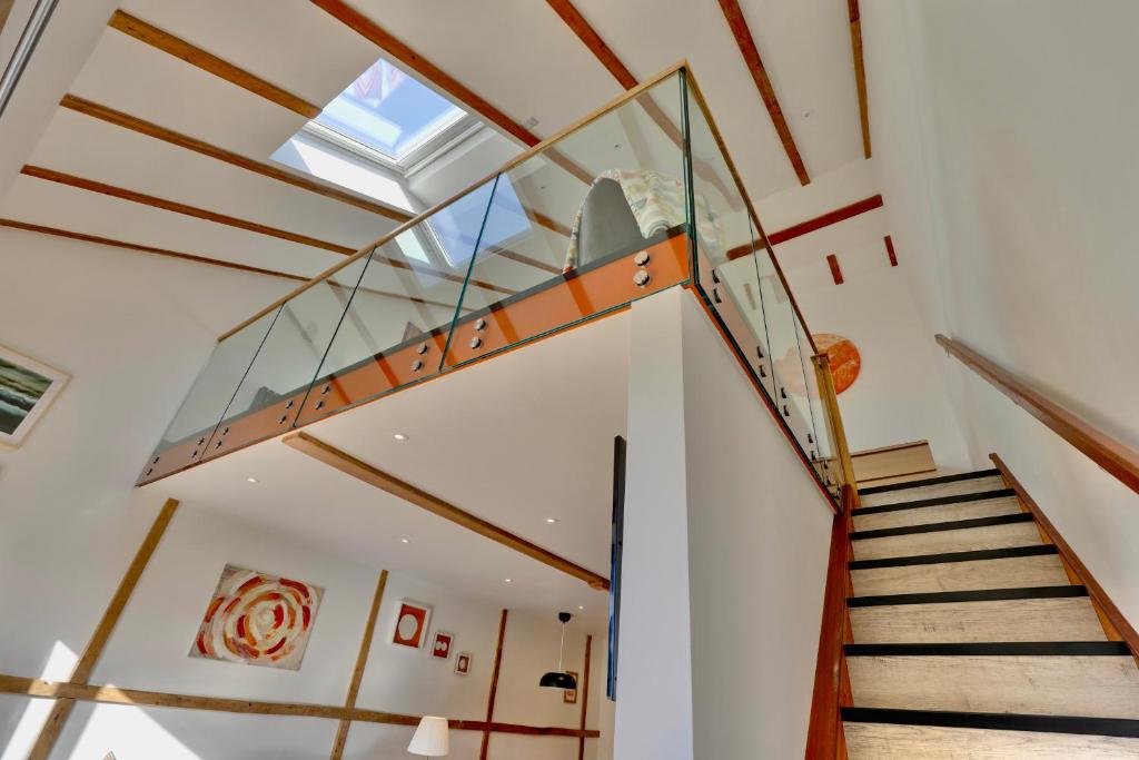 a glass staircase in a house with a ceiling at The Owl Barn Wiltshire - Chalk in Swindon