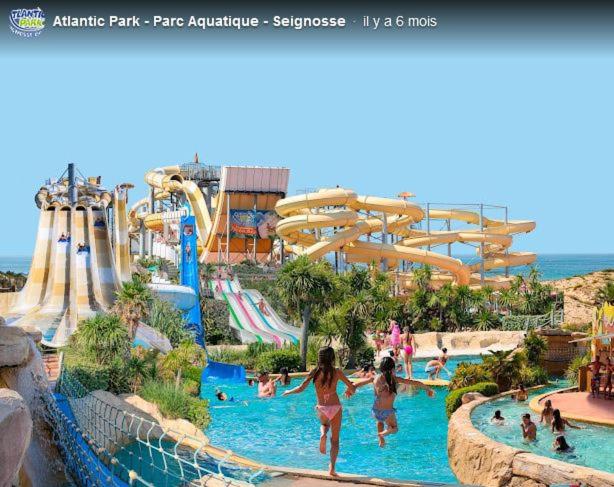 a water park with a water slide and people in it at Chez Alex & Max - Appartement duplex entre forêt et océan in Moliets-et-Maa