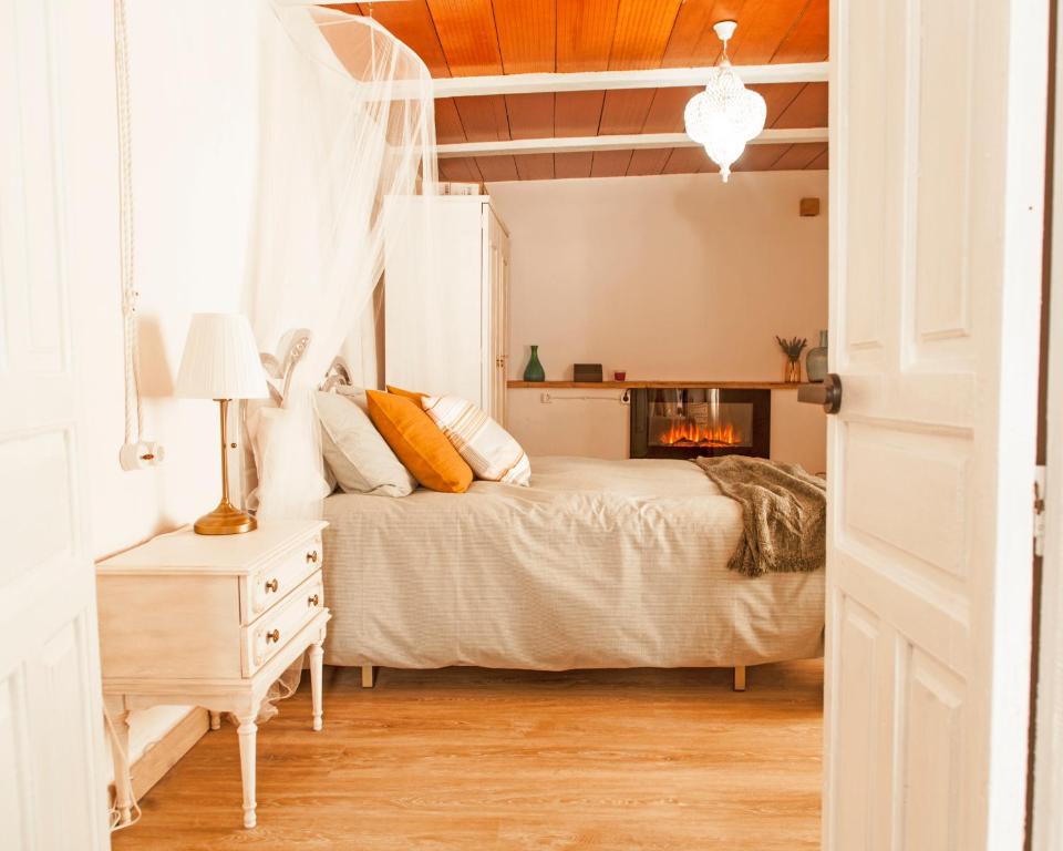 a bedroom with a bed and a fireplace at la casita del pueblo PET friendly granada in Acebuches