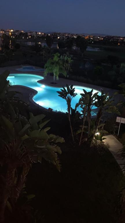 a swimming pool with blue water at night at Casa Paradise, Apartment in Torre-Pacheco